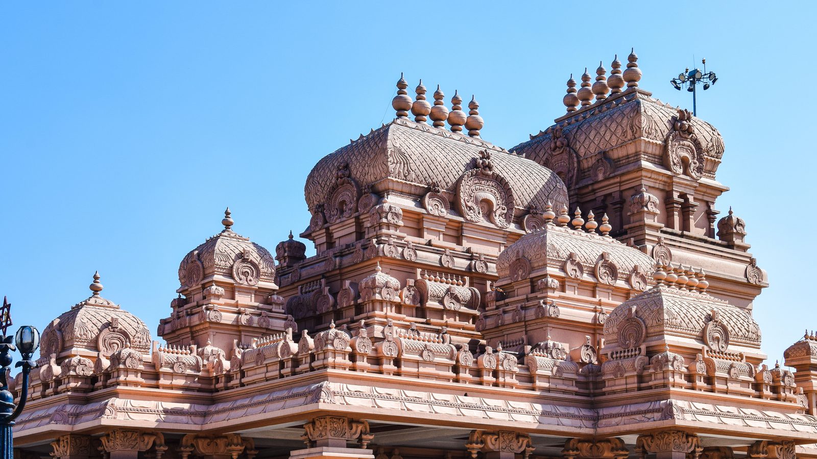 Carved stone vimana finials of a South Indian temple standing against open sky