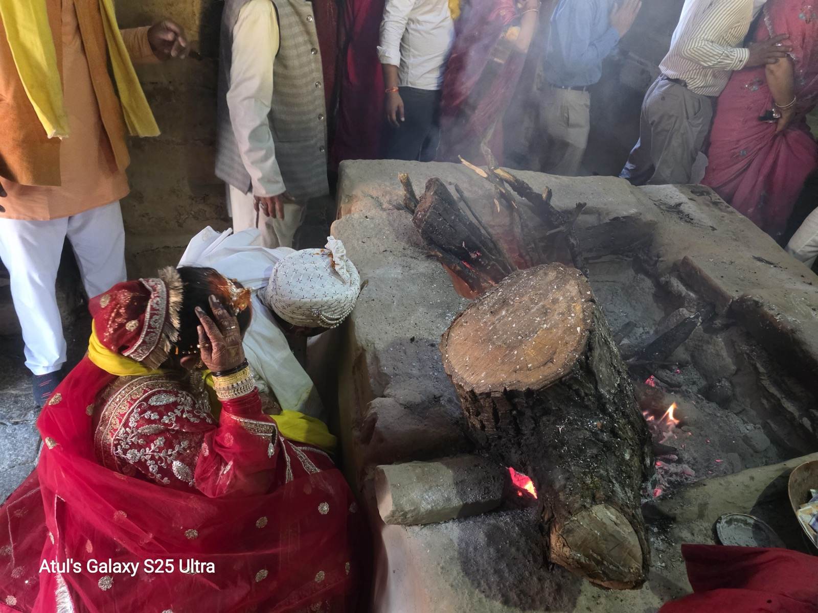 A bride in red praying before the Akhand Dhuni, the eternal flame that has burned since the Satya Yuga at Triyuginarayan