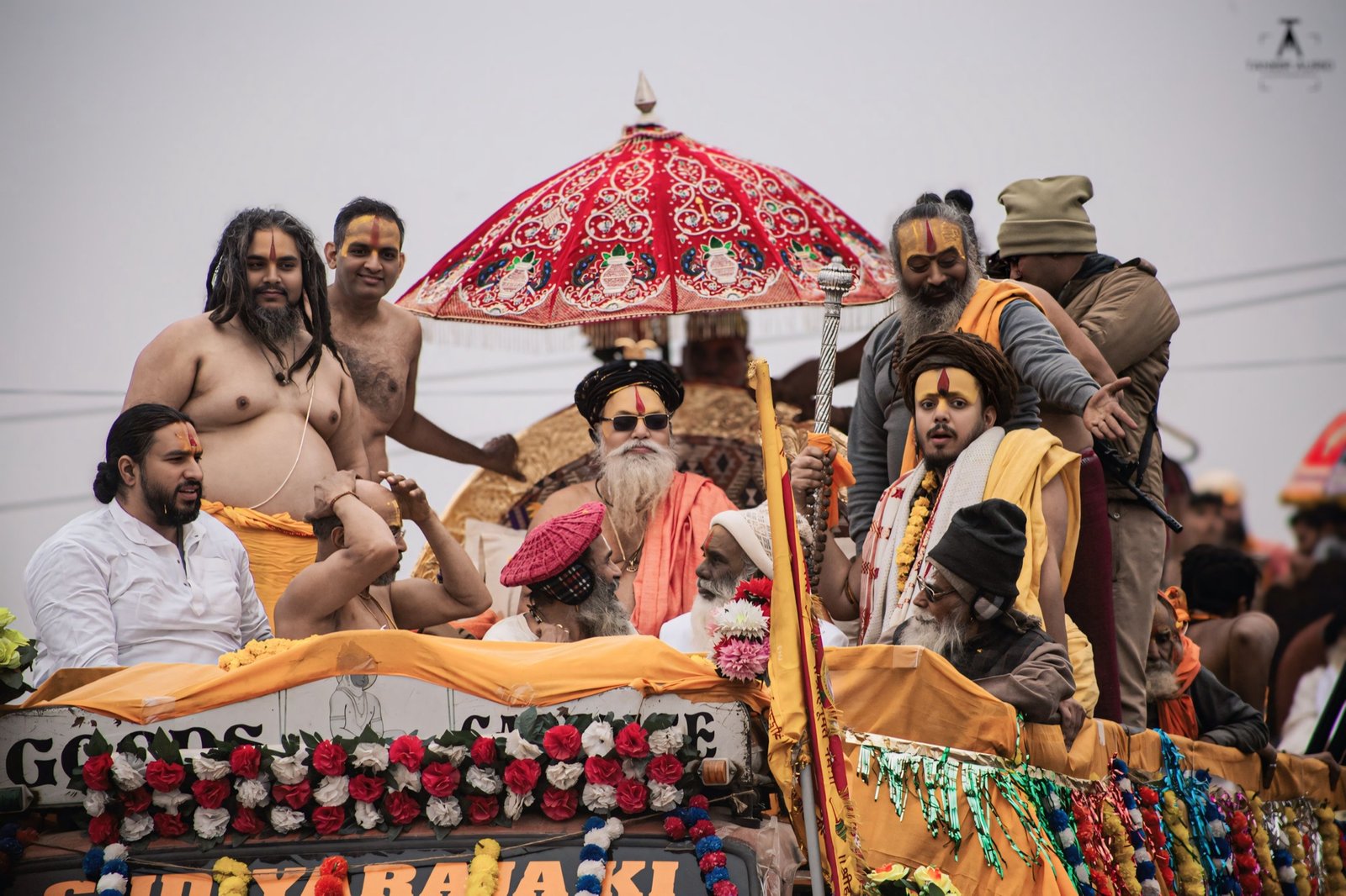 Shahi Snan procession - spiritual leaders under a ceremonial umbrella on a decorated chariot