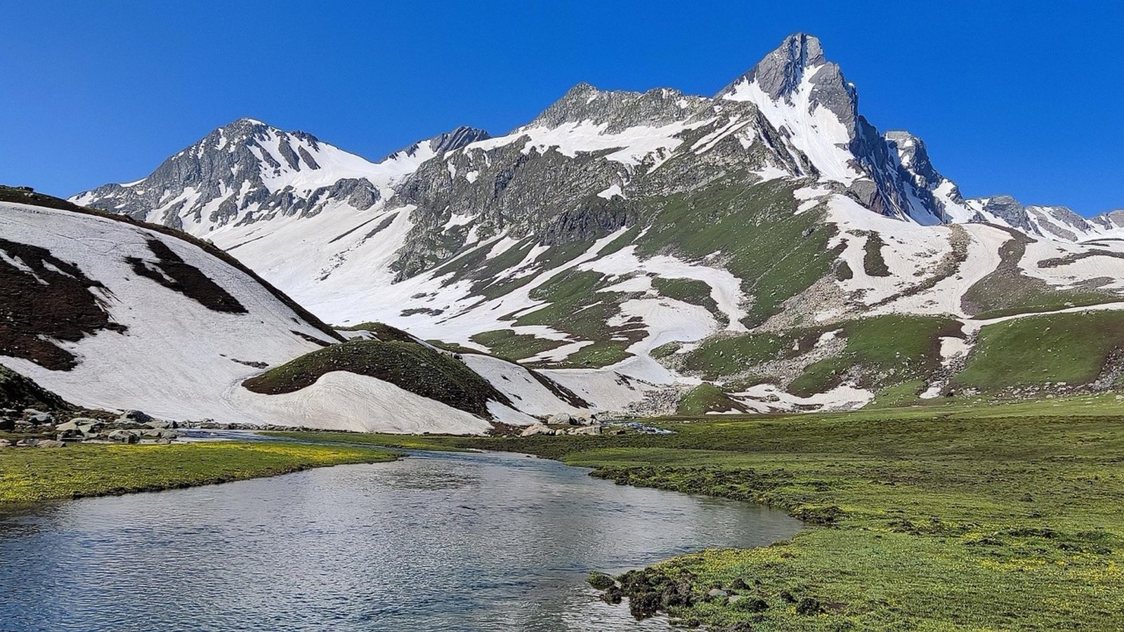 An alpine lake below a snow-covered peak