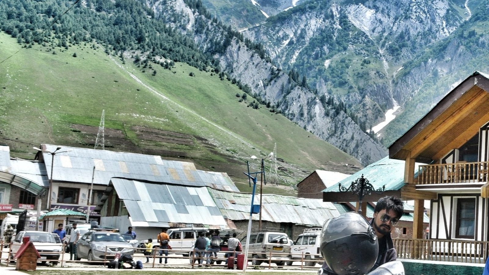 A motorcycle parked at a green valley stop on the Ladakh route
