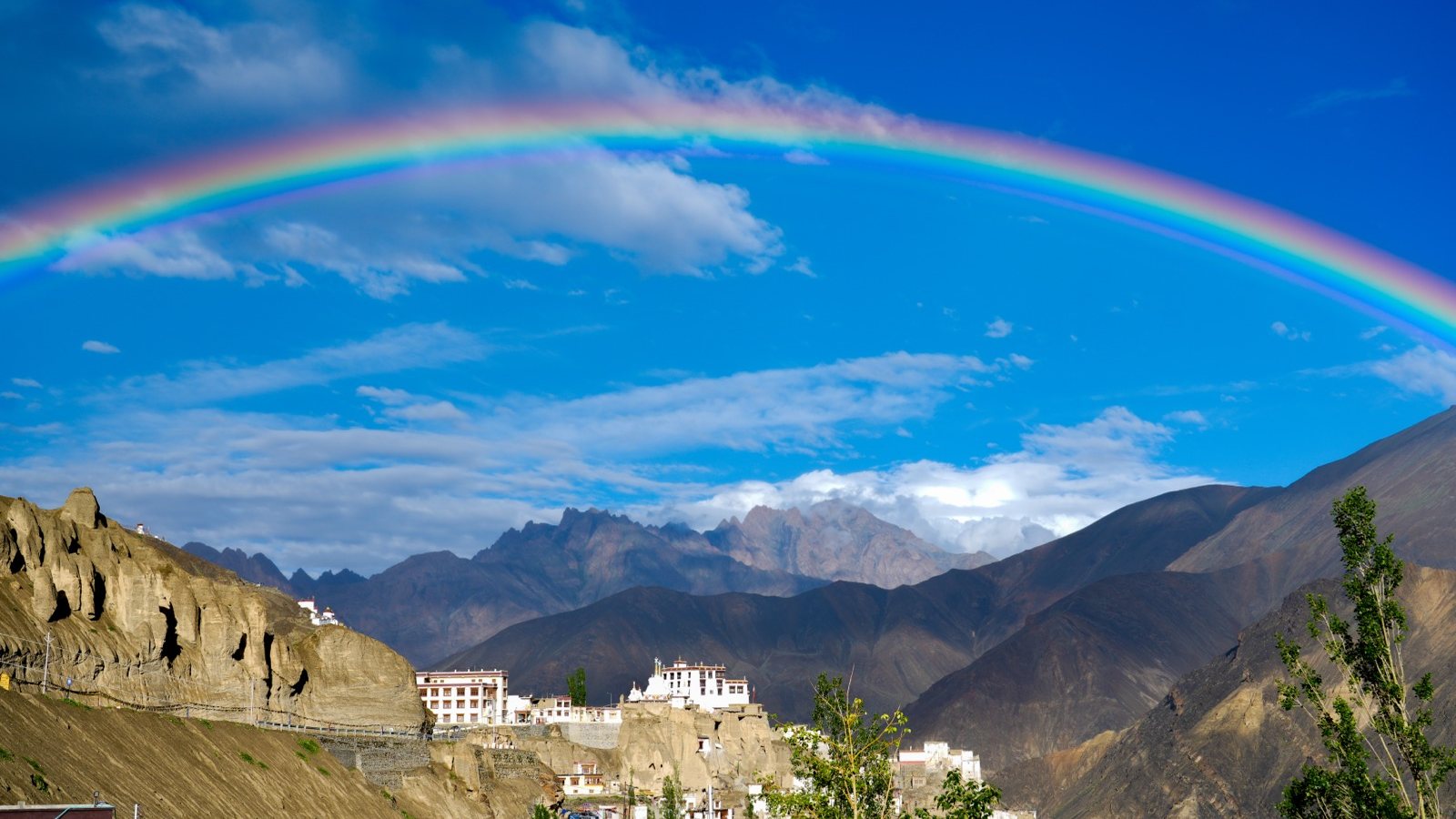 A rainbow arcing over a village in Ladakh