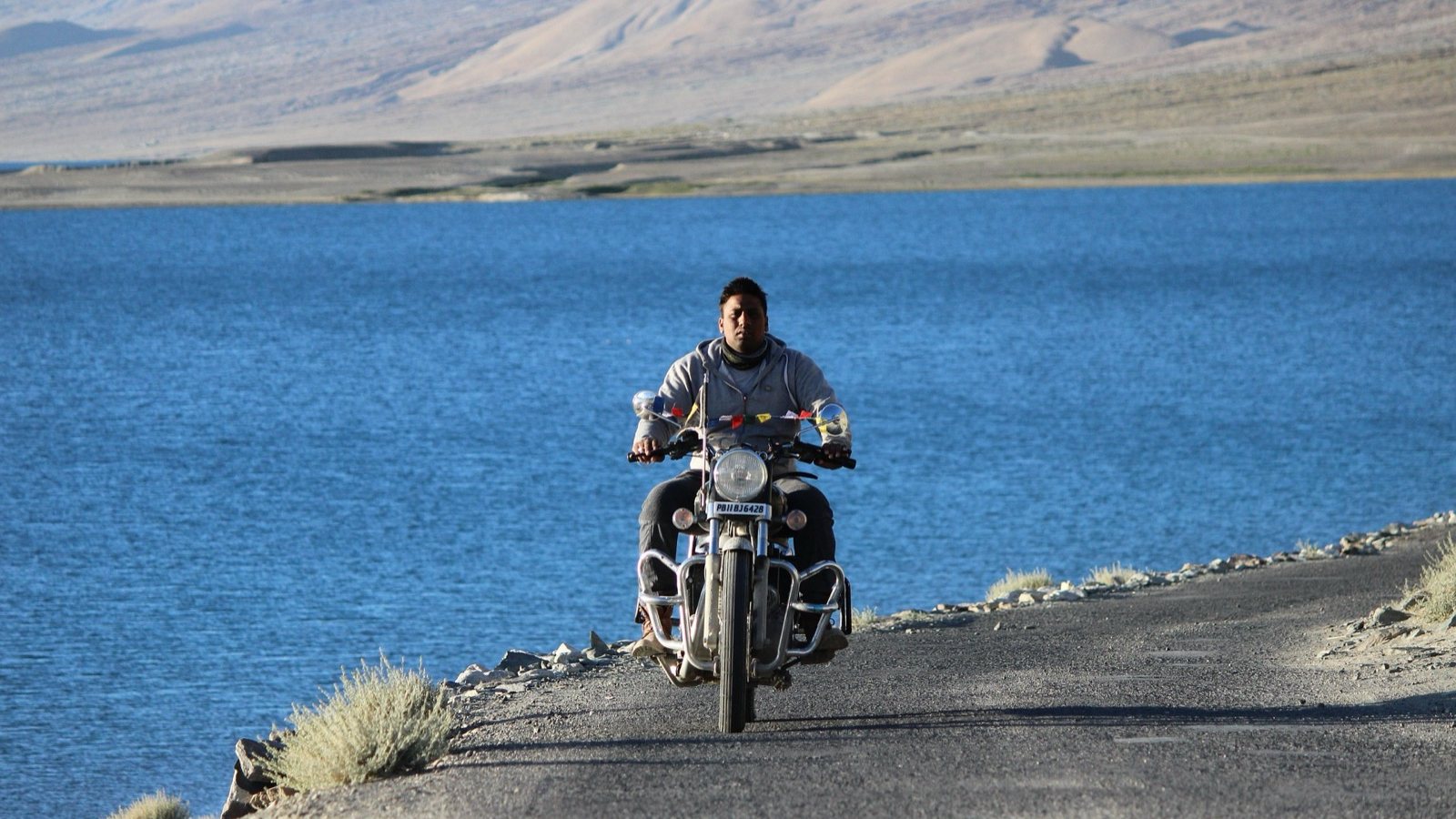 A rider on the road beside Pangong Lake, Ladakh