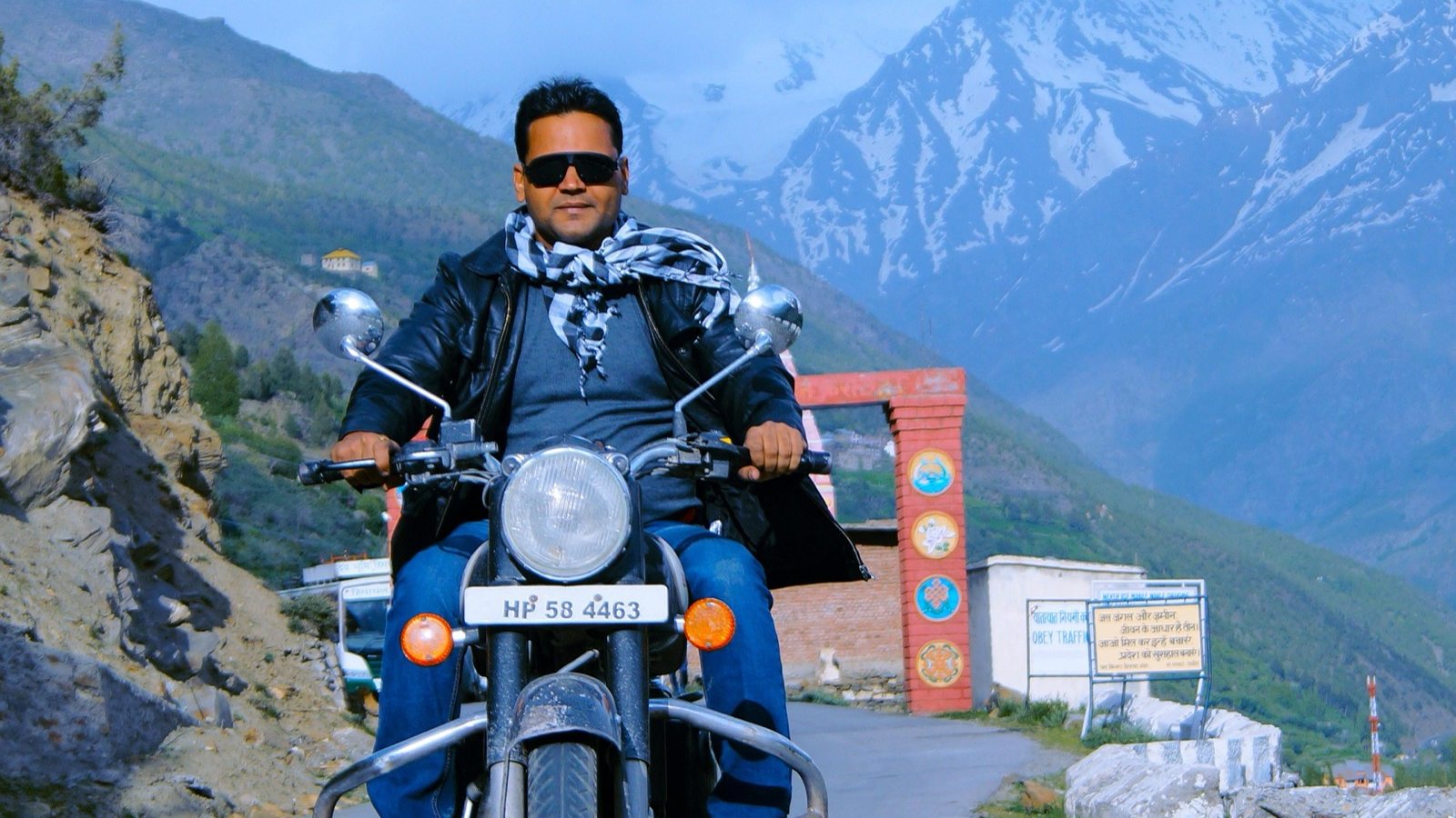 A rider on a Royal Enfield in the Ladakh mountains