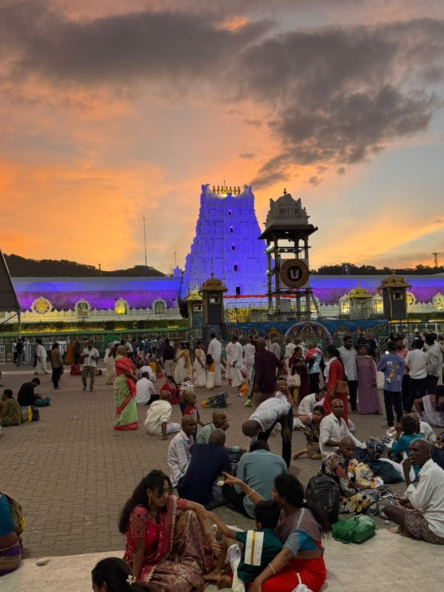 Pilgrims gathered at dusk before an illuminated gopuram on the Pancha Bhoota circuit