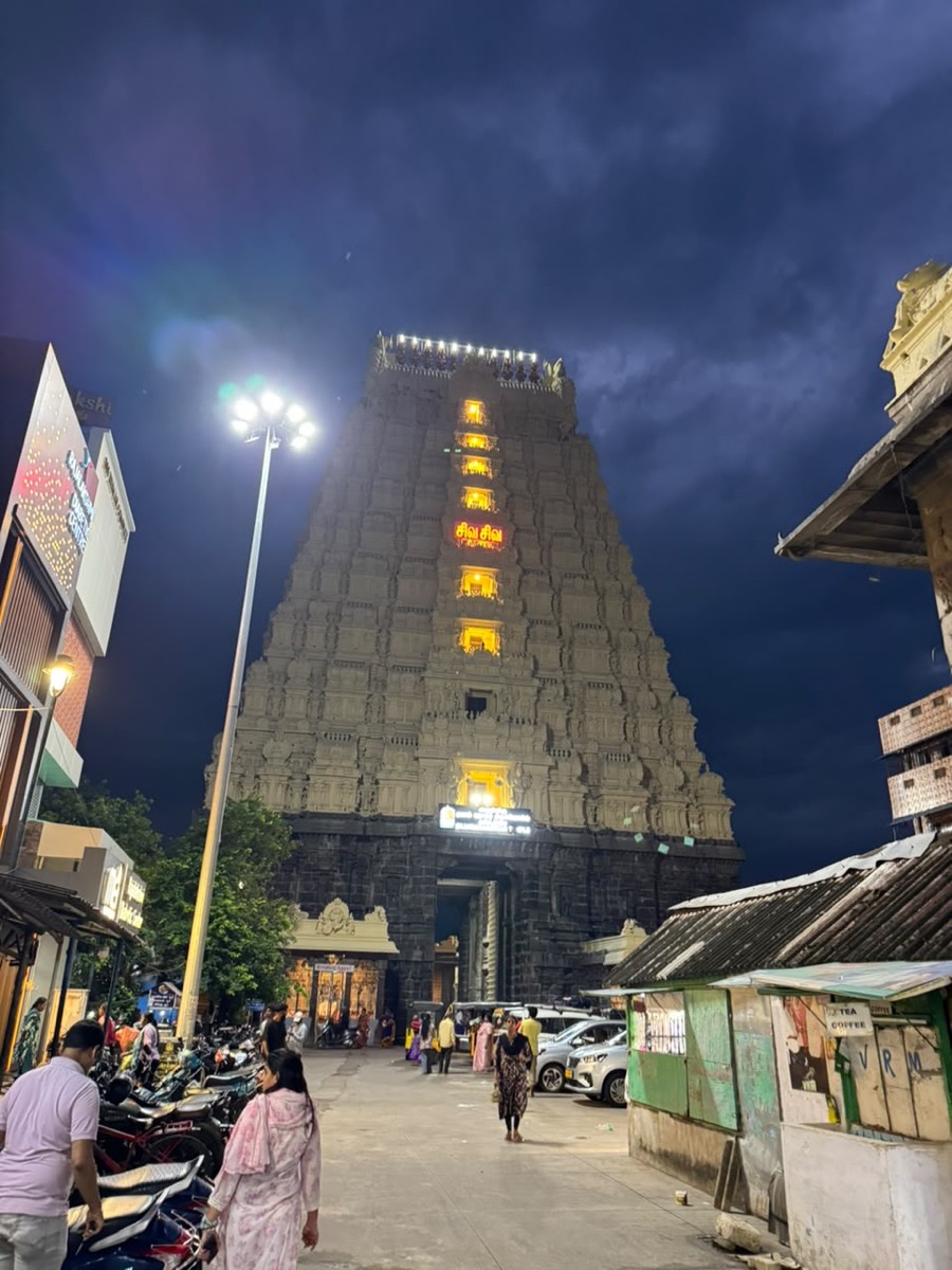 Gopuram tiers lit up against the night sky