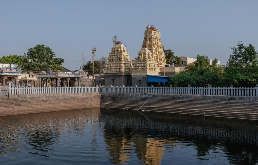 Temple tank with a gopuram reflected in the still water